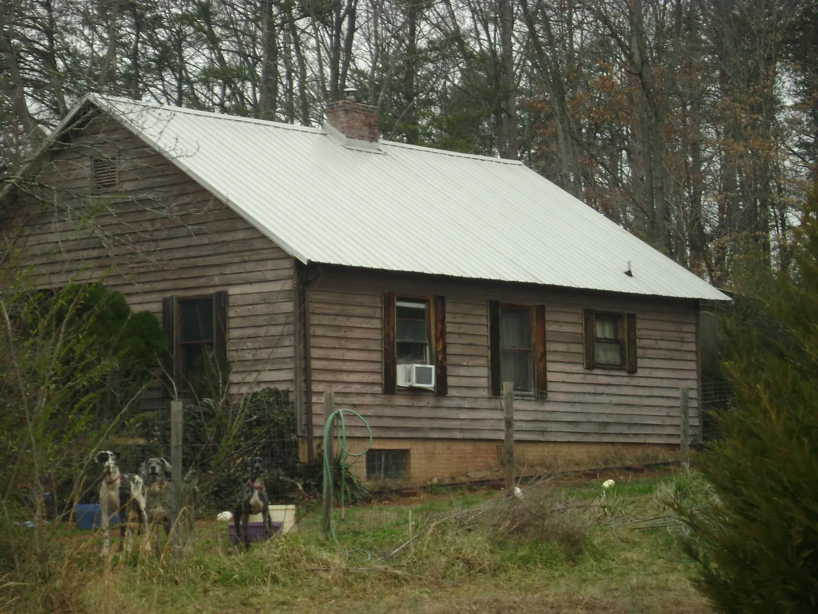 White metal roof on an old wood sided farmhouse, from a Metal Roof Installation job in East Sandwich
